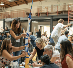 a group of educators building a tower out of paper